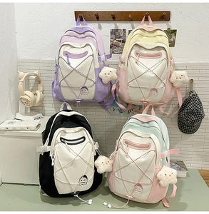 Detail of four colorful student backpacks with star-shaped elastic cords and plush charms