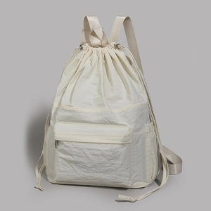 Detail of off-white waterproof nylon backpack with drawstring closure and front zip pocket