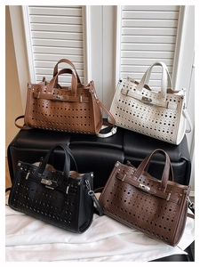Detail of laser-cut hollow pattern on leather tote bags in four classic colors