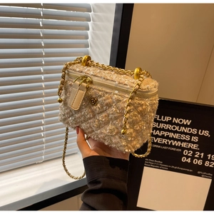 Detailed shot of tweed mini bag with sequins and camellia flower zipper charm
