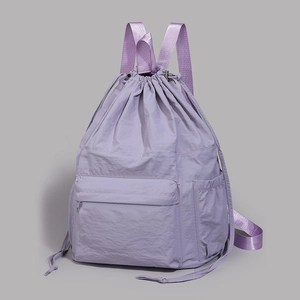 Detailed view of light purple nylon backpack with drawstring closure and water-resistant texture