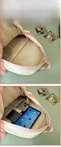Detail view of pink backpack interior showing padded laptop sleeve and multi-layer storage