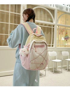 Detail of macaron patchwork backpack with pink elastic cords and plush star pendant