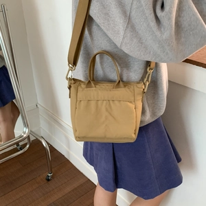 Detail of khaki nylon crossbody bag with adjustable wide fabric shoulder strap for women