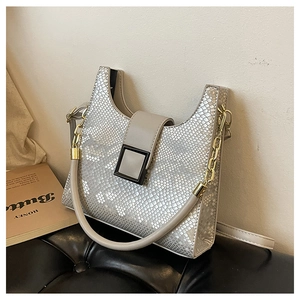 Detail view of silver snake-pattern handbag with metallic texture and black square buckle