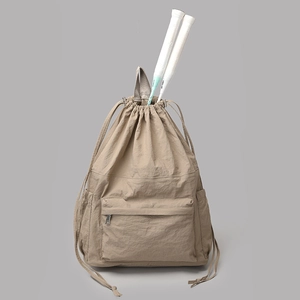 Detail of khaki nylon drawstring backpack showing interior space holding two badminton rackets