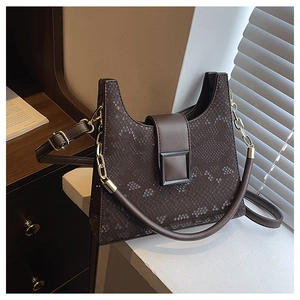 Close-up of deep brown snake-embossed leather texture and stylish metal buckle closure