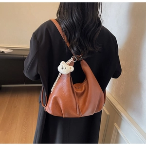 Caramel soft leather shoulder bag with cloud shape and cute plush bear accessory