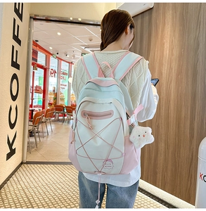 Detail of multi-color school backpack with elastic cords and plush star accessory