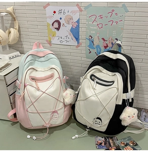 Detail of canvas backpacks featuring elastic drawstrings and plush doll accessories