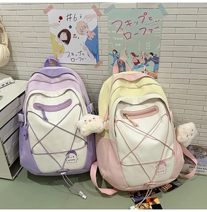 Detail view of macaron pastel school backpacks with star elastic cords and plush charms