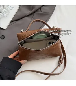 Interior view of brown crocodile texture handbag showing large capacity and zipper