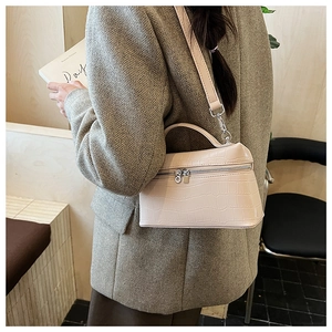 Cream faux crocodile leather mini box bag styled with a grey blazer for a modern look