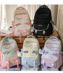 Detail view of colorful school backpacks featuring lace trim and cute bow decorations