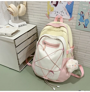 Detail of cute school backpack featuring star elastic cords and purple ghost patch