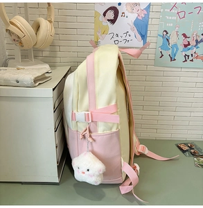 Side view of student backpack in cream and pink with a cute star plush pendant detail