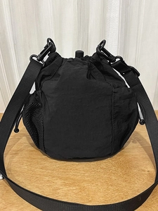 Versatile black nylon drawstring bucket bag with mesh side pockets and adjustable strap