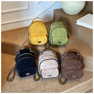 Detail of five colored quilted mini backpacks with elegant chain straps and gold twist locks