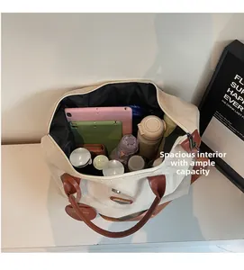Top view of spacious canvas tote interior showing tablets, umbrella and daily essentials