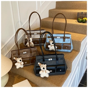 Group photo of four large tote bags in black, brown, blue and grey with plush bear charms