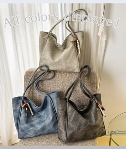 Three oversized washed leather tote bags in grey and blue with beaded tassel details