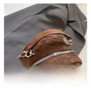 Detail shot of brown frosted leather backpack with quilted pattern and round handle
