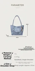 Detail view of large grey-blue PU tote bag with dimensions and bohemian tassel charm