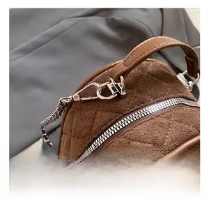 Close-up of brown frosted leather backpack with quilted lattice and silver hardware details