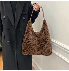 Close-up of leopard print faux fur tote bag with brown leather straps for women