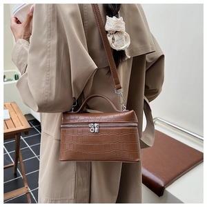 Detailed view of the dark brown crocodile pattern texture on this small crossbody bag