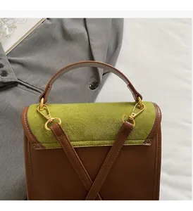 Detail view of glossy gold hardware and olive green matte texture on retro backpack