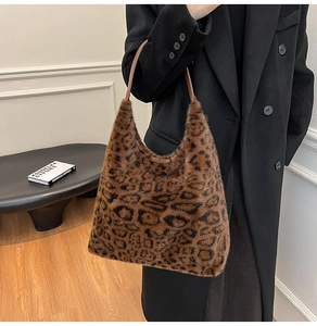 Detail view of leopard print faux fur tote bag showing the soft texture and slim handle