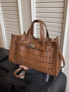 Brown hollow-out leather handbag with classic metal twist-lock and shoulder strap for women