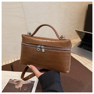 Brown crocodile embossed leather handbag showing dual-way zipper and sleek handle