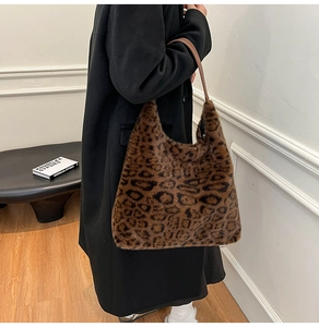 Faux mink leopard print tote bag styled with a long black winter coat on model