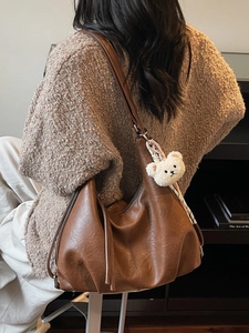 Brown leather hobo shoulder bag with fringe tassel and plush bear charm decoration