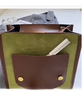 Detail of vintage patchwork backpack with olive suede pocket and lipstick storage