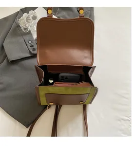 Macro detail of the spacious interior of a vintage brown and green flap backpack