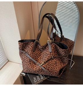 Detail of leopard print tote bag showing fine texture and golden metal buckle hardware