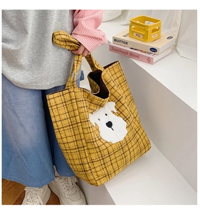 Detail of yellow plaid tote bag featuring a cute white dog patch embroidery and large interior