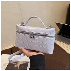 Detail of lavender crocodile pattern rectangular crossbody bag with silver hardware zipper