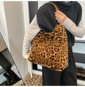 Detail of soft leopard print faux fur tote bag with premium brown leather strap