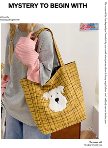 Detail view of yellow plaid canvas tote bag with a white schnauzer plush patch