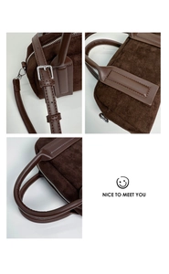 Detail of dark brown suede bowling bag featuring silver hardware and adjustable strap