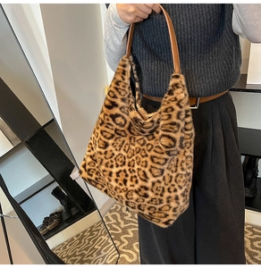Close-up of leopard print faux fur tote bag with brown leather shoulder strap
