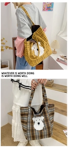 Detailed view of the large plaid tote bag featuring a cute white dog patch and shoulder straps