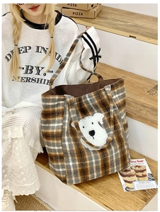 Detail of retro plaid tote bag featuring a cute puppy patch in cozy warm brown colors