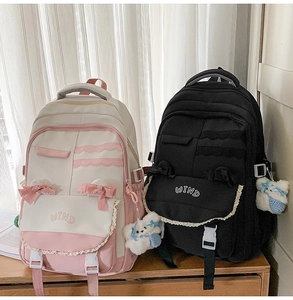 Detail of school backpacks with lace trim, cute bow ties, and plush bear keychain accessories