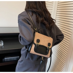 Detailed back view of model wearing a vintage two-tone frosted leather backpack