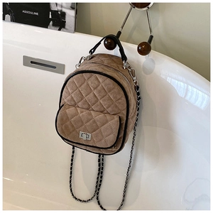 Detail of khaki quilted mini backpack with chain strap and silver twist lock closure